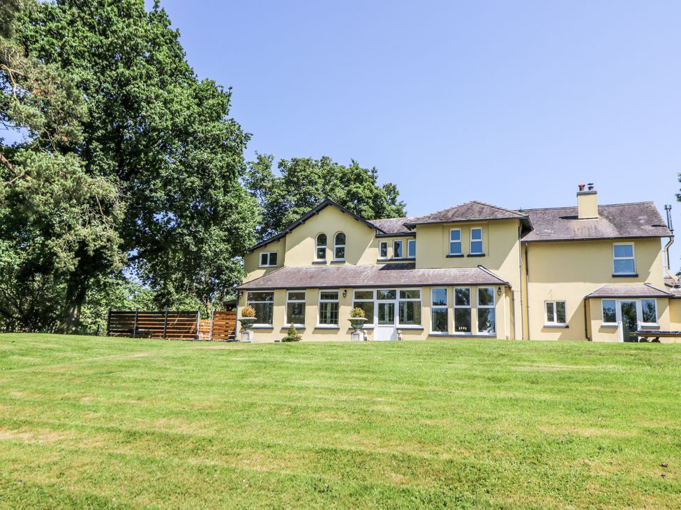 A house with windows and grass area at Glanrannell Park House Llanwrda