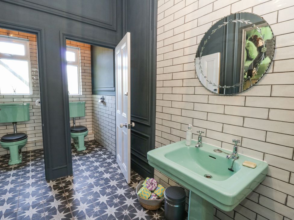 A bathroom with a sink and two toilets at Glanrannell Park House in Llanwrda