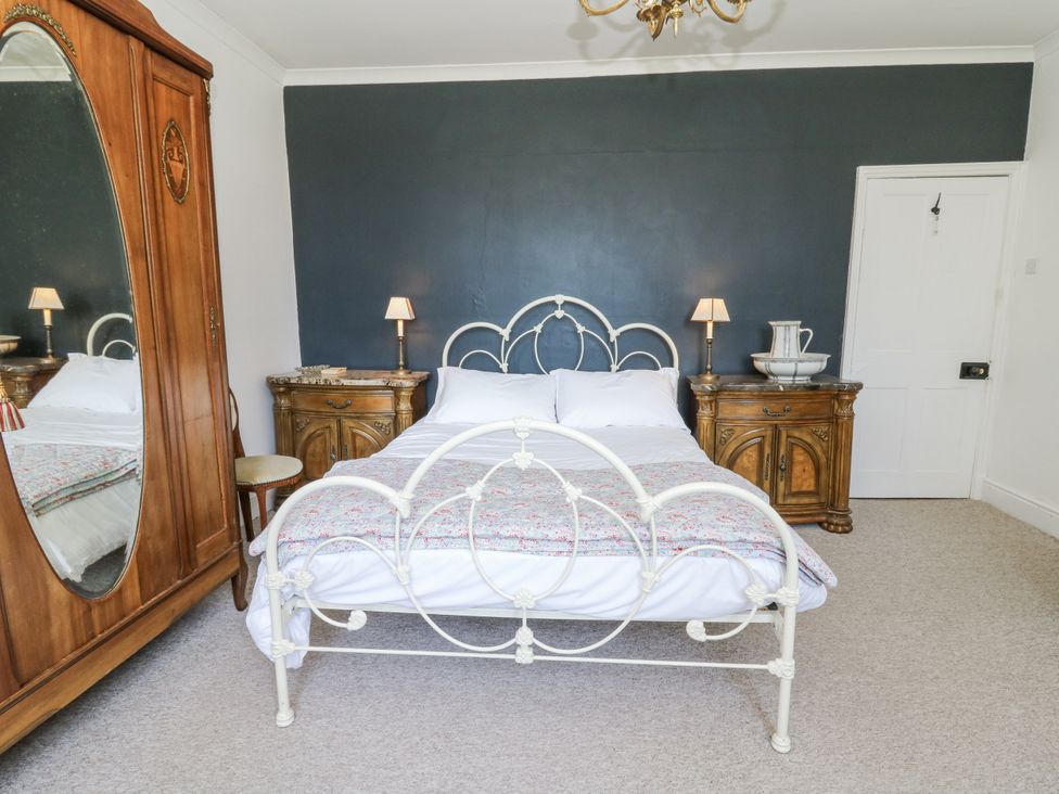 A bedroom with a bed and furniture at Glanrannell Park House in Llanwrda