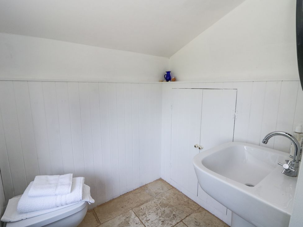 A bathroom with a toilet and sink at Glanrannell Park House in Llanwrda