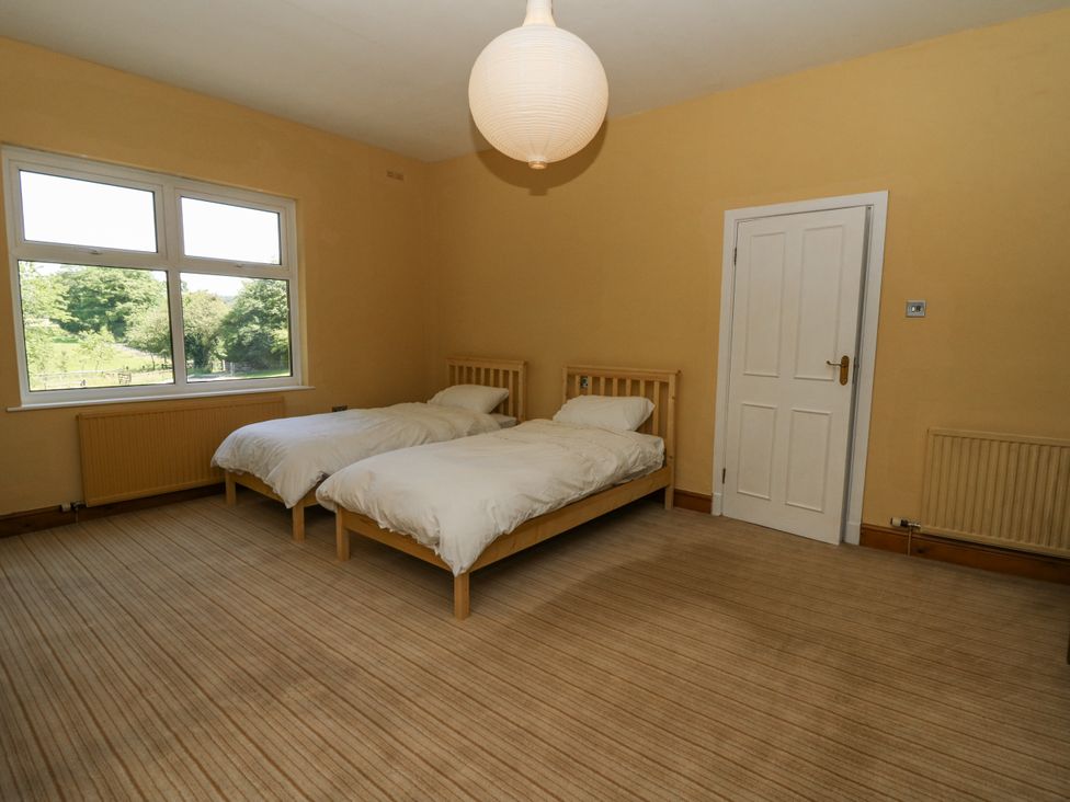 A bedroom with two beds and a window at Glanrannell Park House in Llanwrda