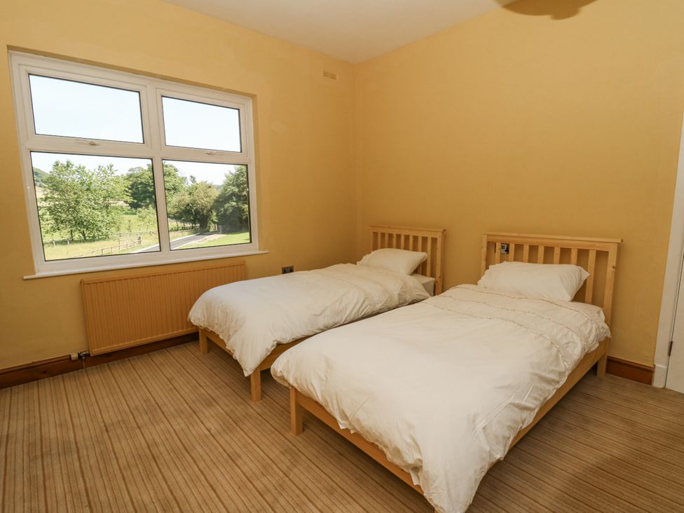 A bedroom with two beds and a window at Glanrannell Park House Llanwrda
