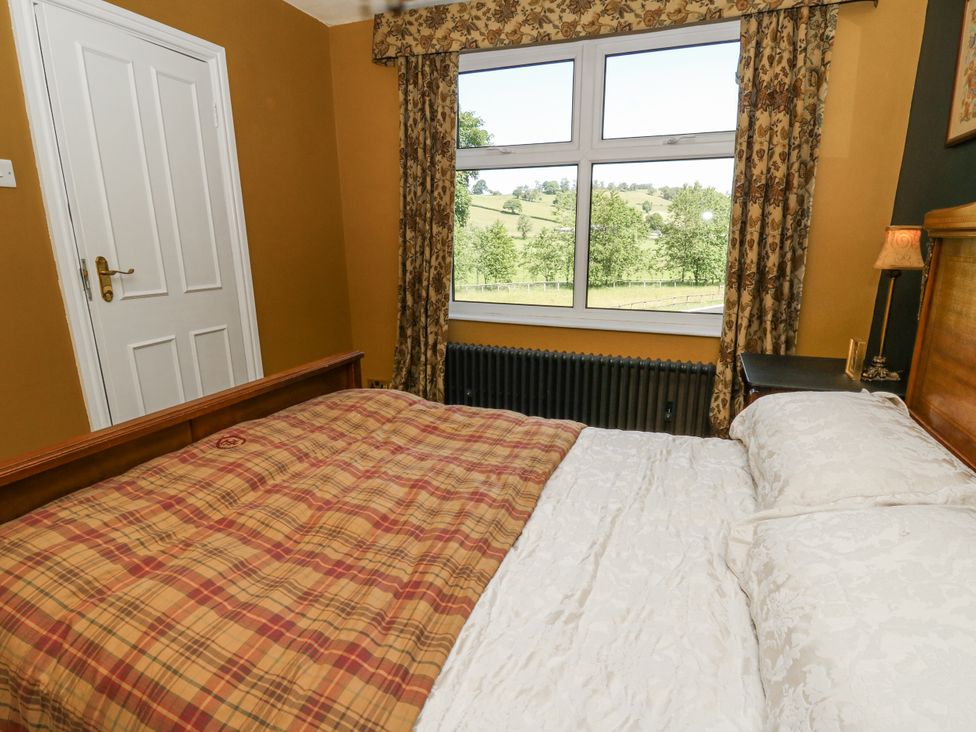A bedroom with a bed and window at Glanrannell Park House Llanwrda