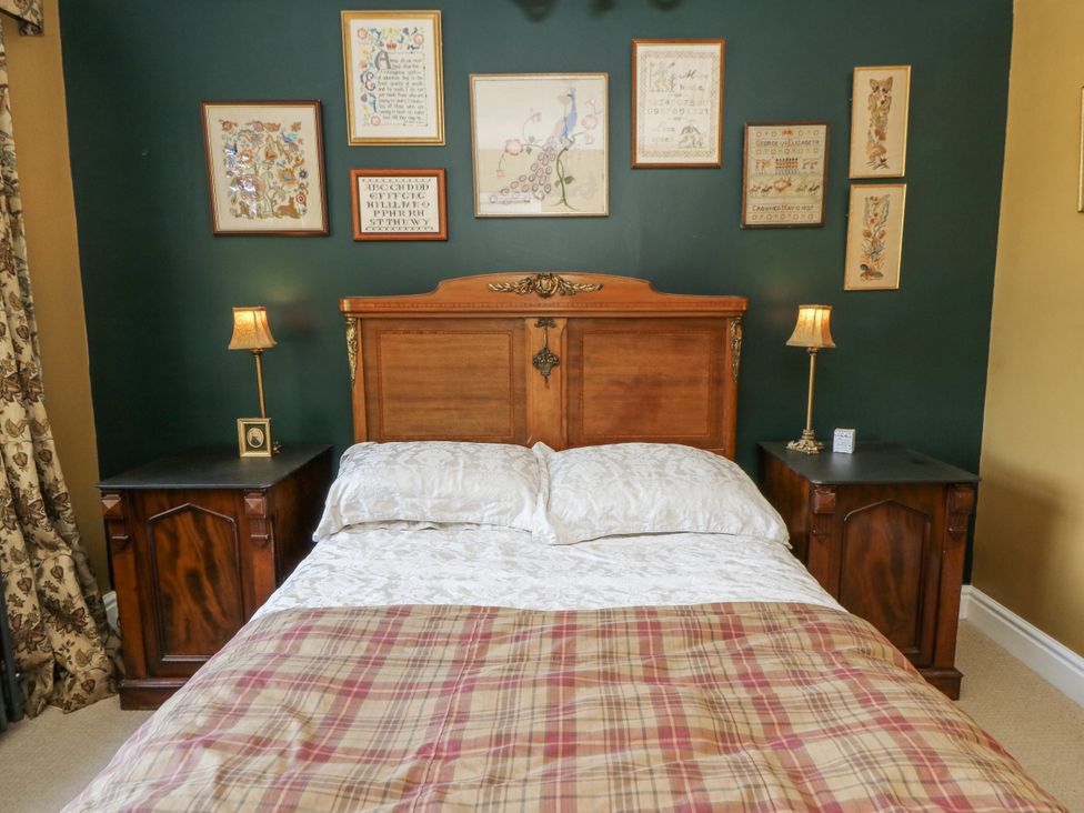 A bedroom with a bed and bedside tables at Glanrannell Park House Llanwrda