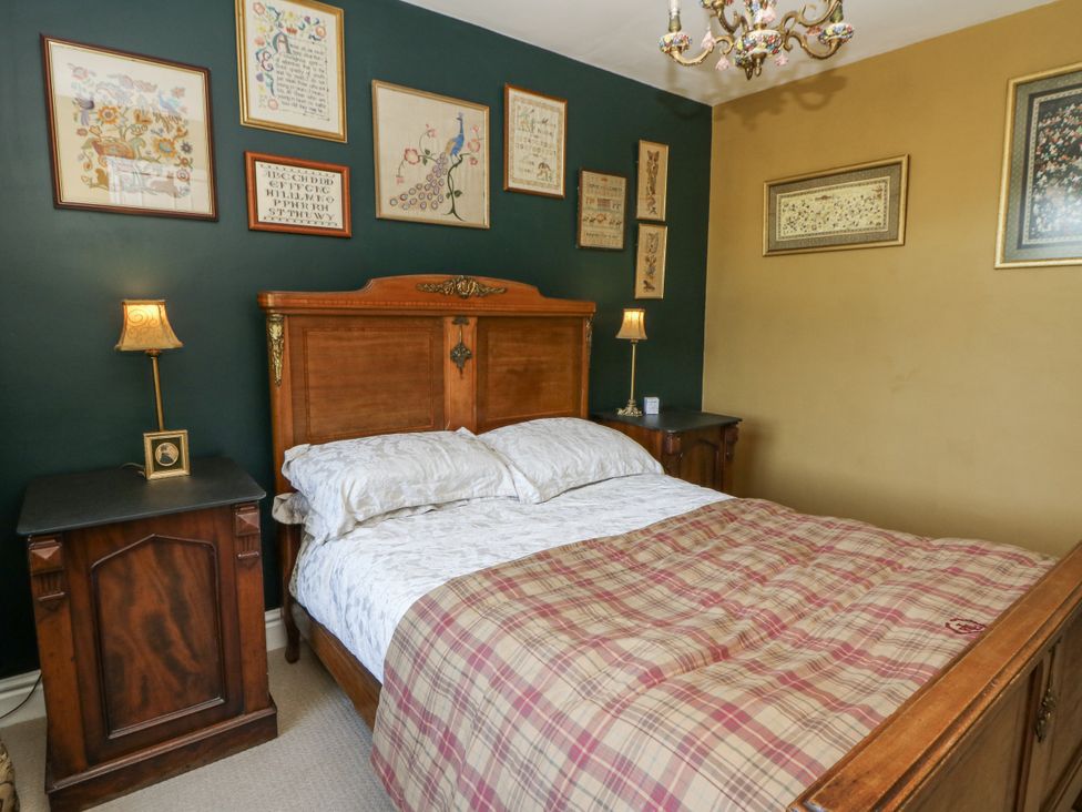 A bedroom with a bed and wall art at Glanrannell Park House in Llanwrda