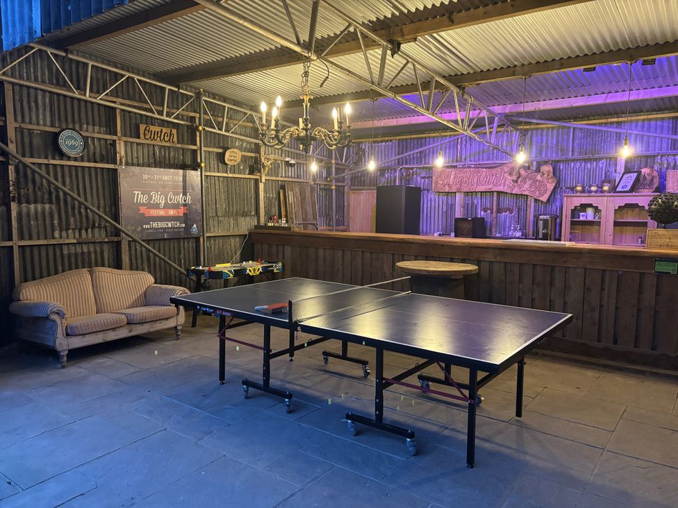 A recreational area with a ping pong table and a bar at The Retreat at Glanrannell Park House in Llansawel