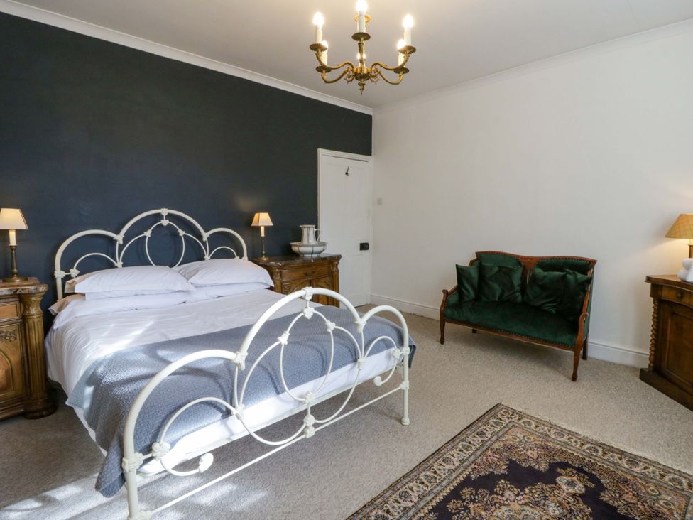 A bedroom with a bed and nightstands at The Retreat at Glanrannell Park House Llansawel