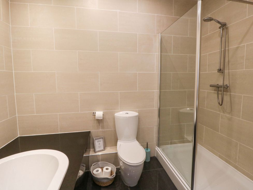 A bathroom with a shower and a toilet at The Retreat at Glanrannell Park House in Llansawel
