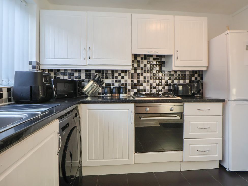 A kitchen with appliances and cabinets at Anfield Stadium House in Liverpool