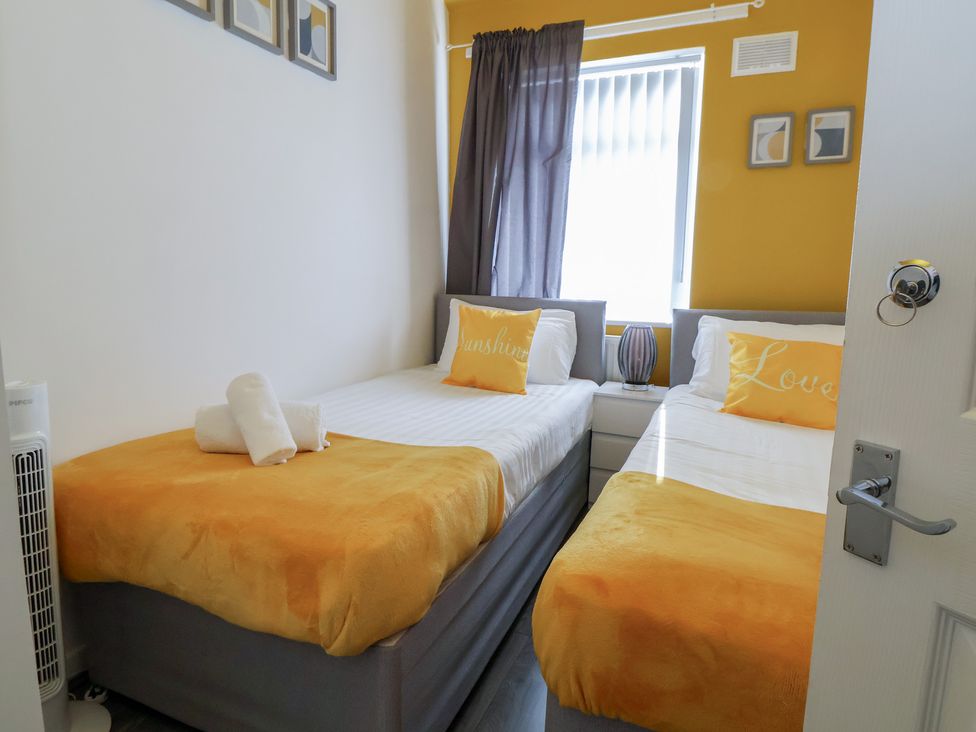 A bedroom with two beds and a lamp at Anfield Stadium House, Liverpool