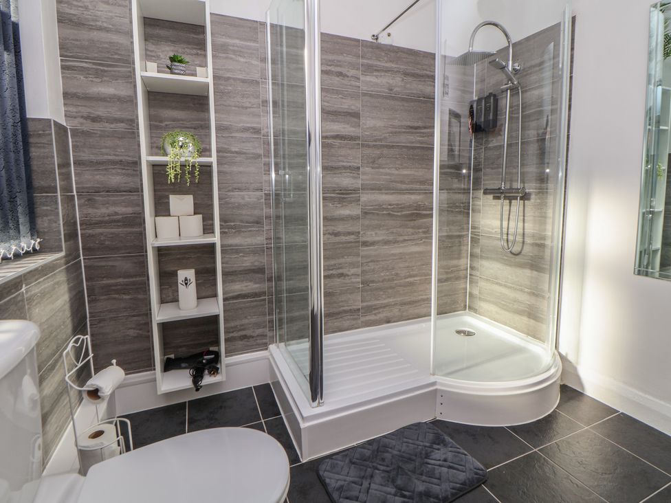 A bathroom with a shower and toilet at Anfield Stadium House in Liverpool