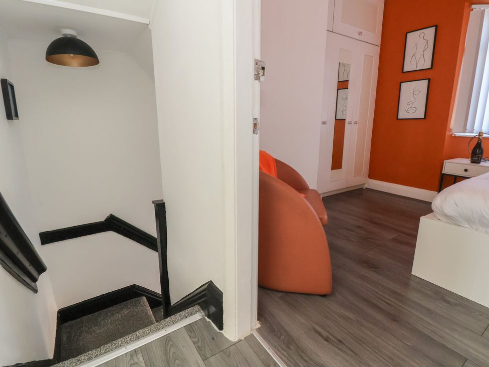 A bedroom with stairs and a lamp at Anfield Stadium House in Liverpool