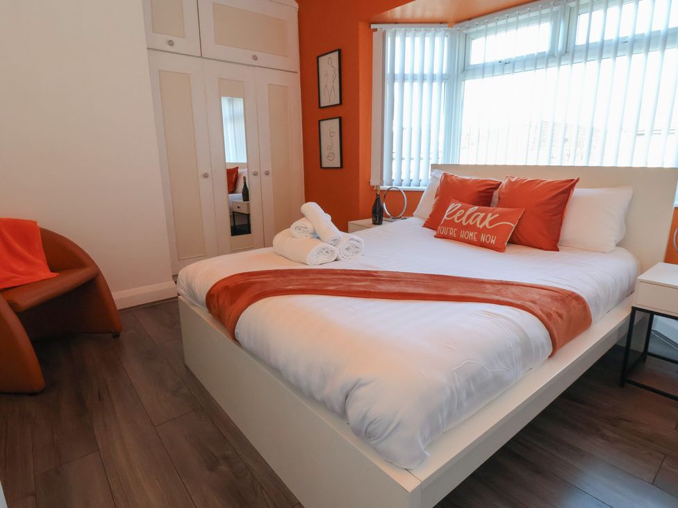 A bedroom with a bed and wardrobe at Anfield Stadium House in Liverpool