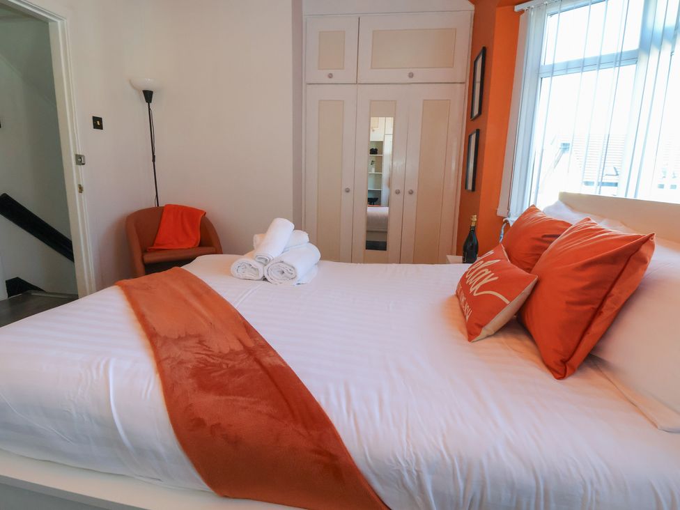 A bedroom with a bed and an armchair at Anfield Stadium House Liverpool