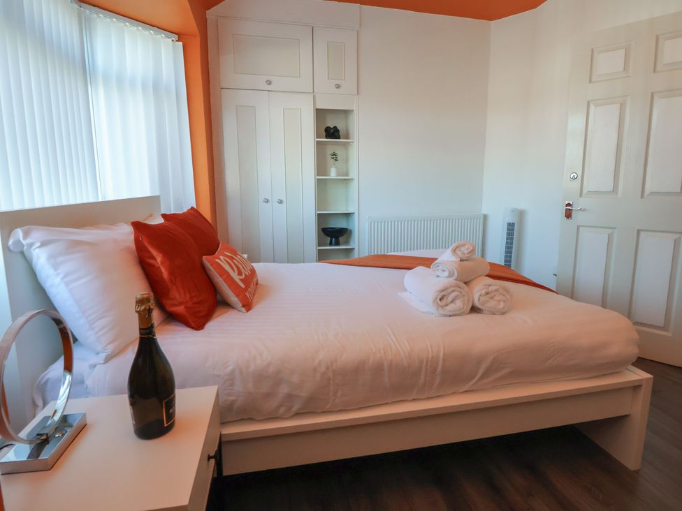 A bedroom with a bed and towels on the bed at Anfield Stadium House in Liverpool