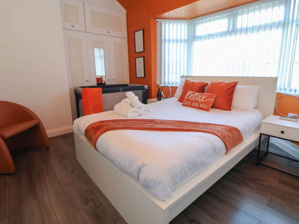 A bedroom with a bed and a chair at Anfield Stadium House Liverpool