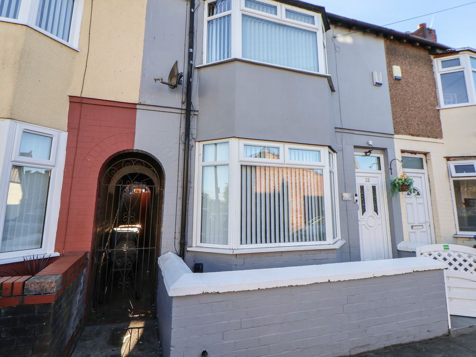 A house facade featuring a door and windows at Anfield Stadium House in Liverpool
