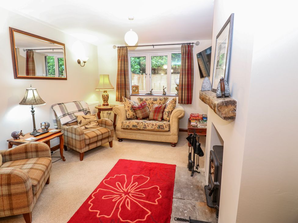 A living room with a sofa and armchairs at Coldbeck Cottage in Ravenstonedale