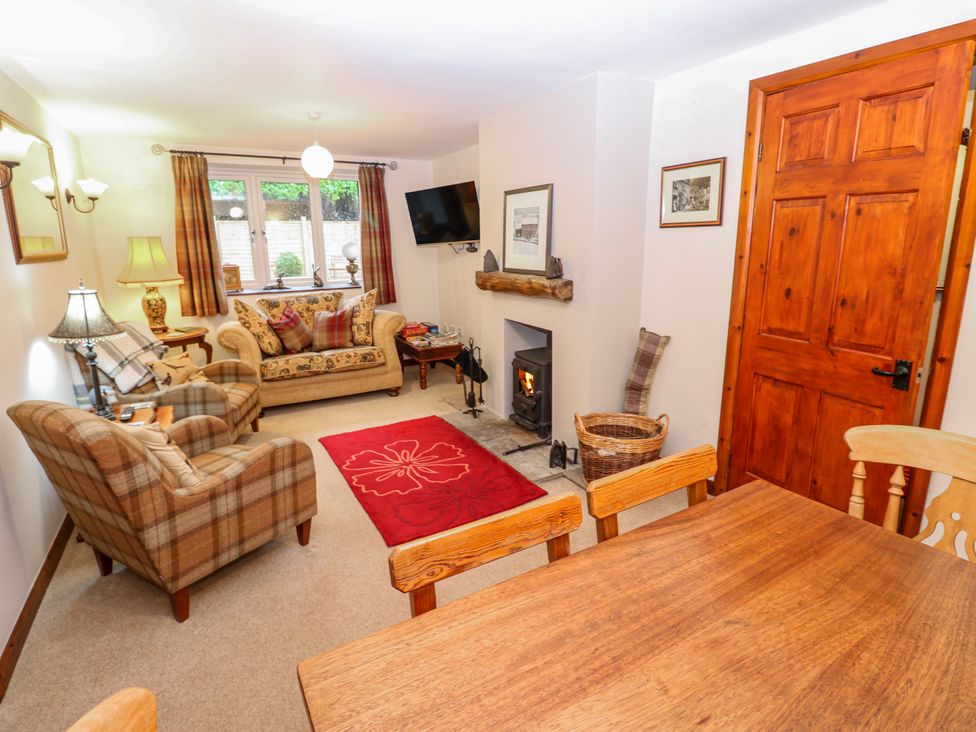 A living room with furniture and a fireplace at Coldbeck Cottage in Ravenstonedale