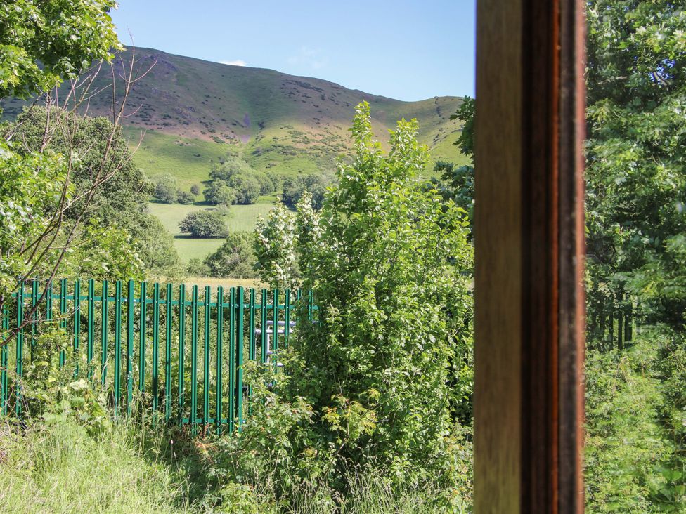 A view of hills and greenery from a window at The Miller’s Roost at Dudgeley Mill All Stretton near Church Stretton