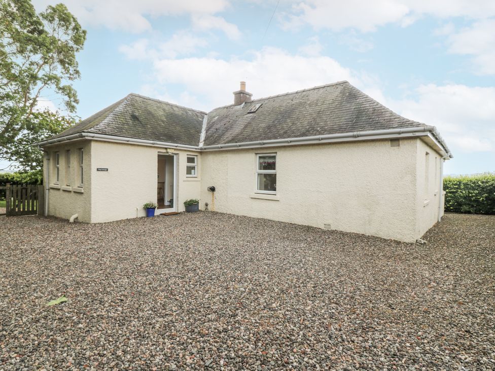 A house exterior with gravel driveway and planter at Top Cottage in Cupar, Fife