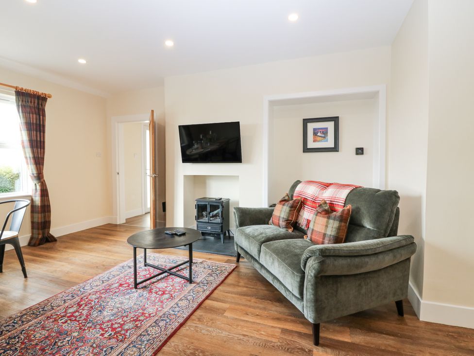 A living room with a sofa and television at Top Cottage Cupar, Fife