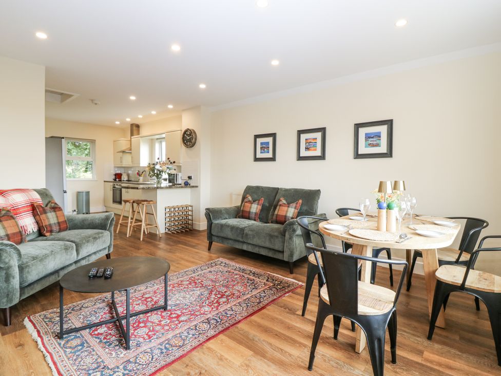 A living room with a sofa and dining table at Top Cottage in Cupar, Fife