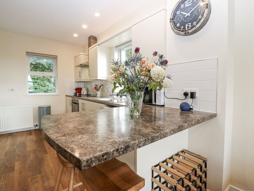 A kitchen with counter and flowers at Top Cottage Cupar, Fife