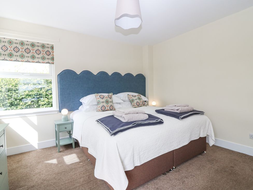 A bedroom with a bed and bedside tables at Top Cottage in Cupar, Fife