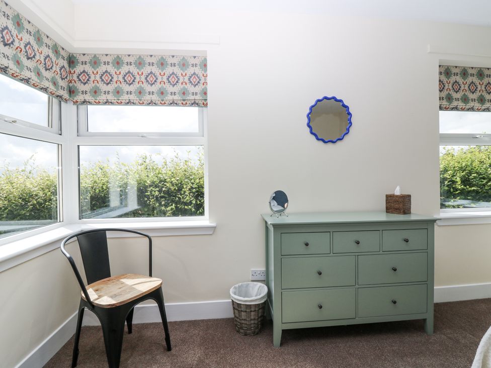 A bedroom with windows and a dresser at Top Cottage, Cupar, Fife