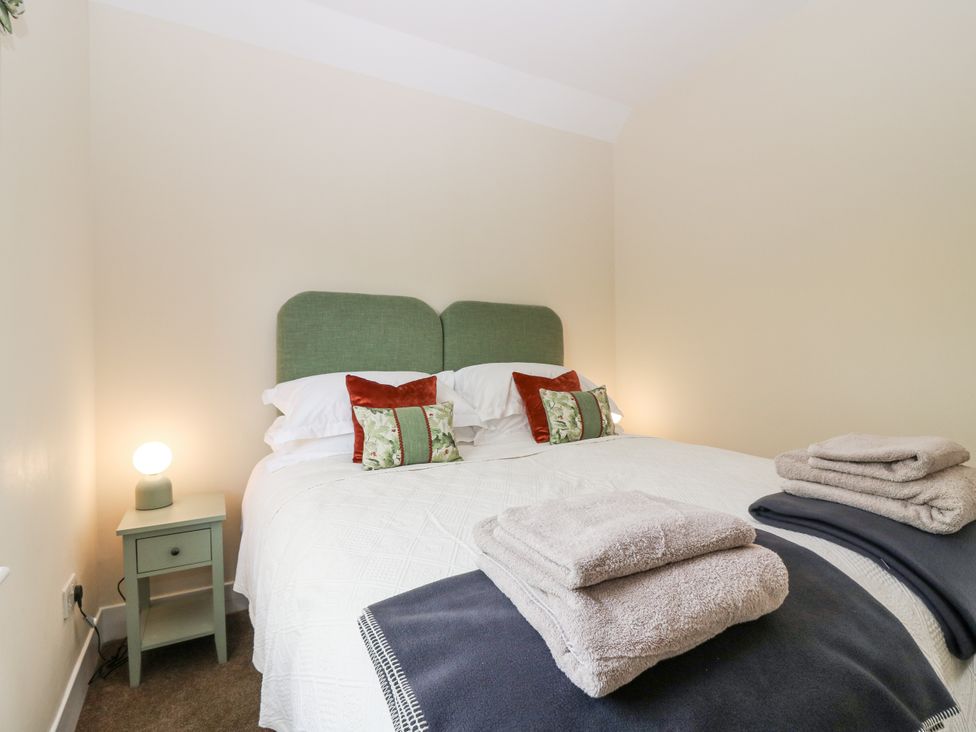 A bedroom with a double bed and a bedside table at Top Cottage in Cupar, Fife