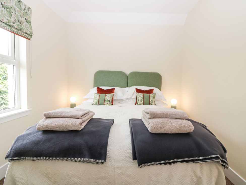 A bedroom with a bed and pillows at Top Cottage, Cupar, Fife