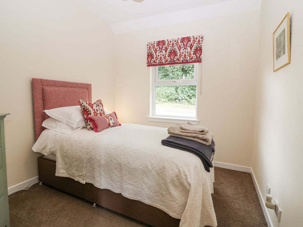 A bedroom with a bed and window at Top Cottage in Cupar, Fife