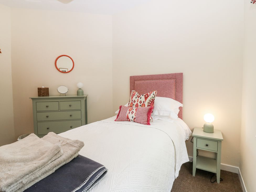 A bedroom with a bed and nightstand at Top Cottage, Cupar, Fife