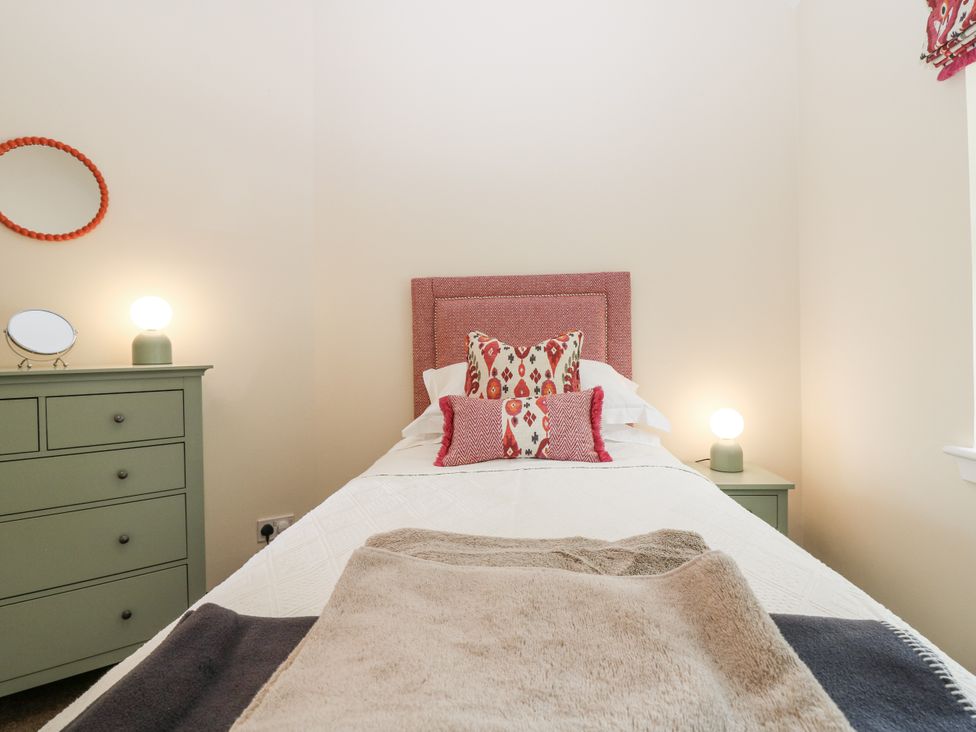 A bedroom with a single bed and a dresser at Top Cottage, Cupar, Fife
