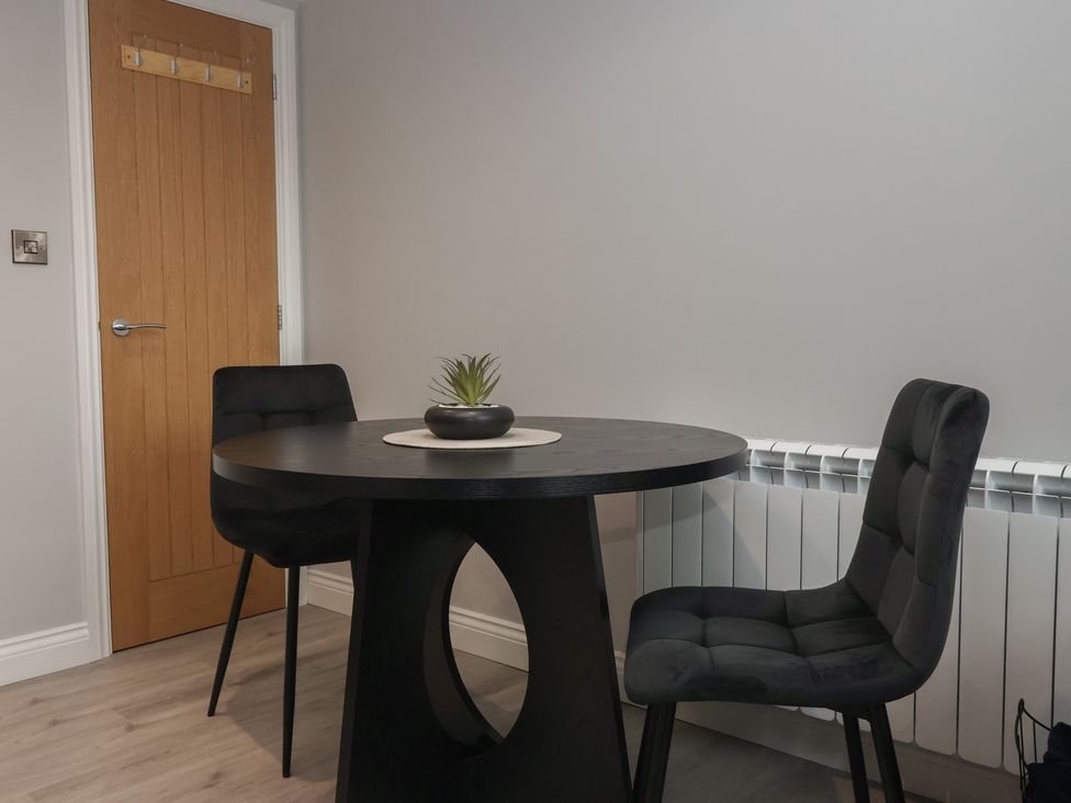 A dining room with a table and chairs at Canal Side in Skipton