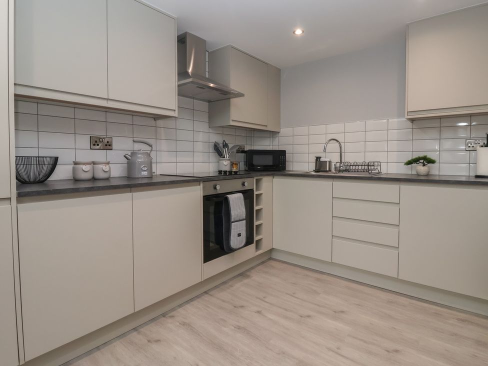 A kitchen with appliances and storage at Canal Side in Skipton