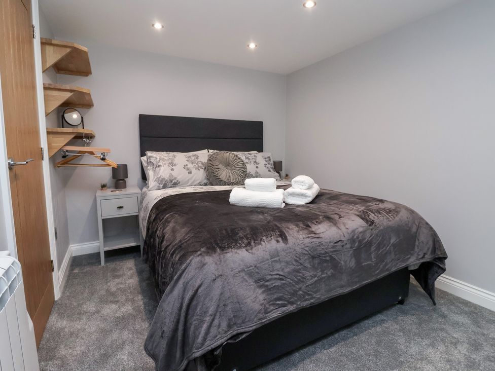 A bedroom with a bed and bedside table at Canal Side in Skipton