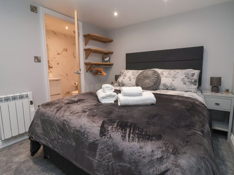 A bedroom with a bed and towels at Canal Side in Skipton