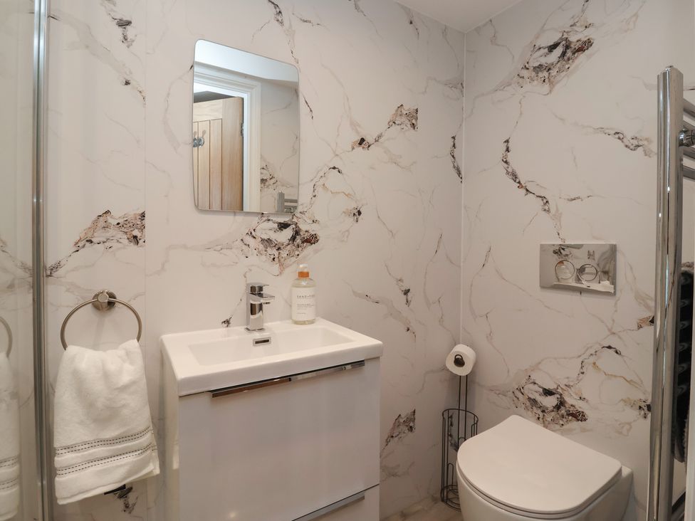 A bathroom with a sink and mirror at Canal Side Skipton