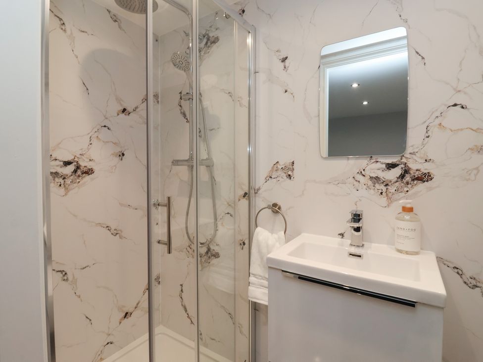A bathroom with a shower and sink at Canal Side in Skipton