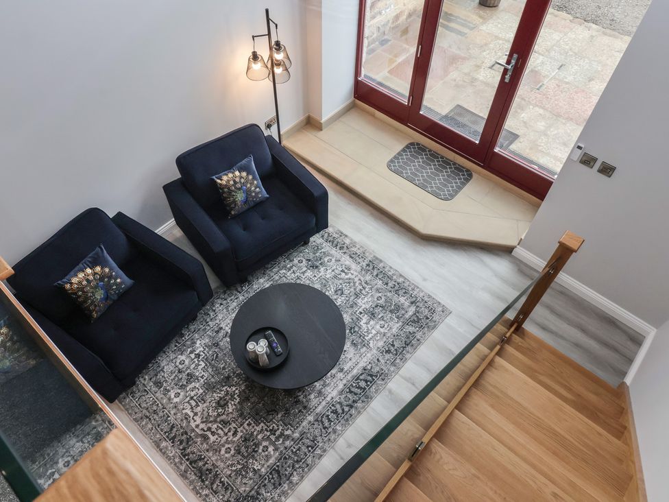 A living room with two armchairs and a round table at Canal Side in Skipton