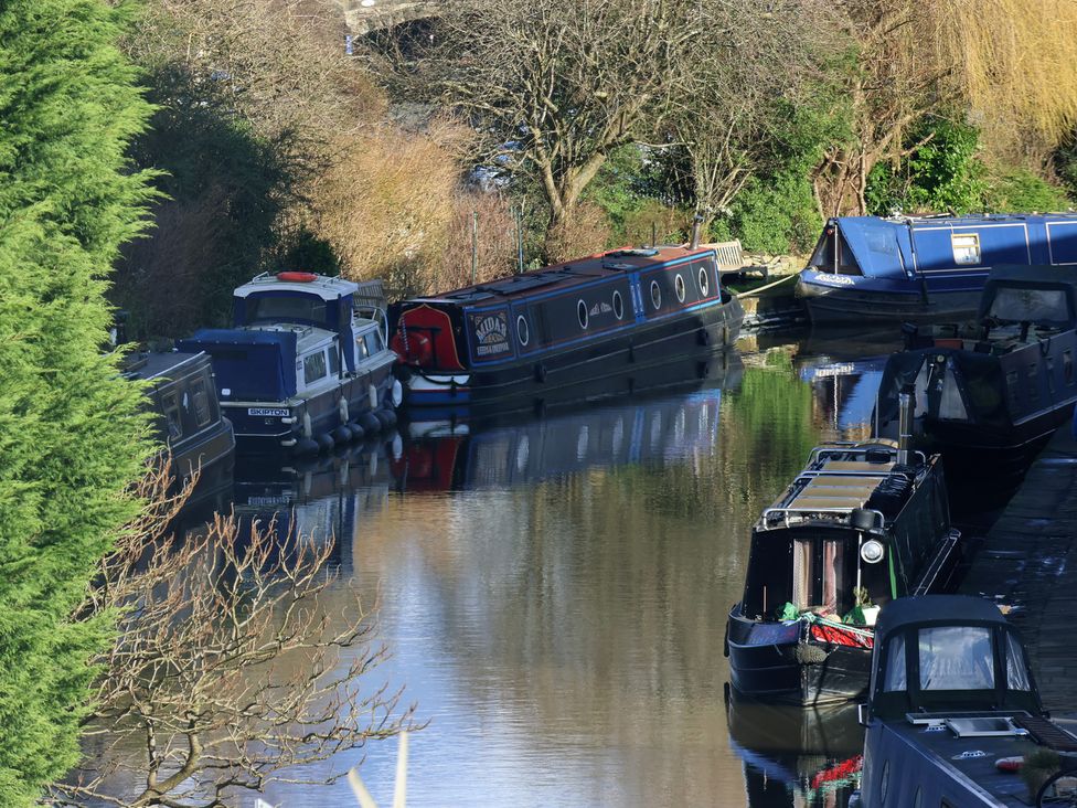 A view of narrowboats moored on a canal at Canal Side in Skipton