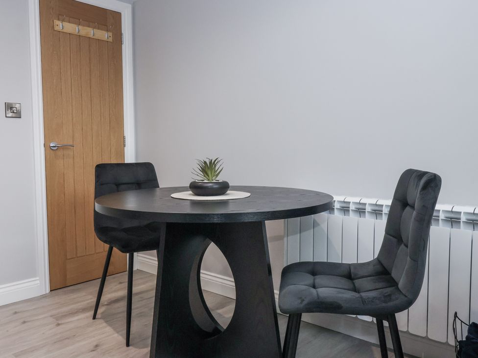 A dining room with a table and chairs at Waters Edge in Skipton