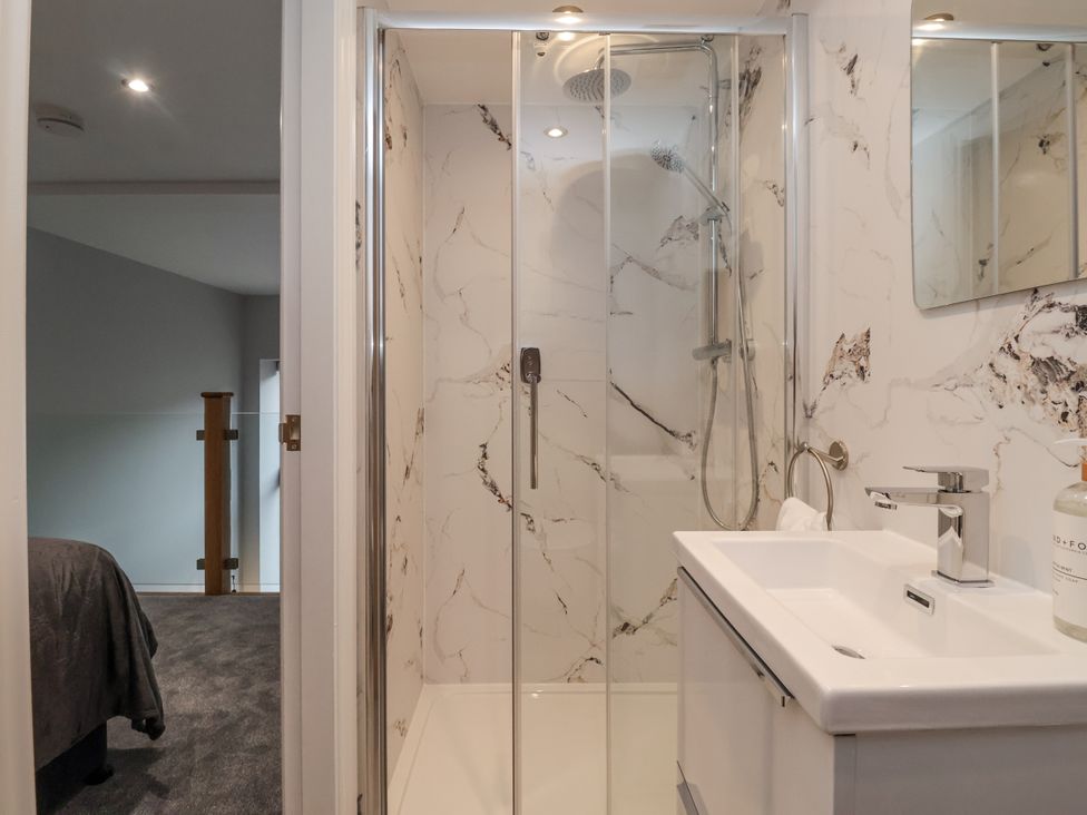 A bathroom with a shower and sink at Waters Edge in Skipton
