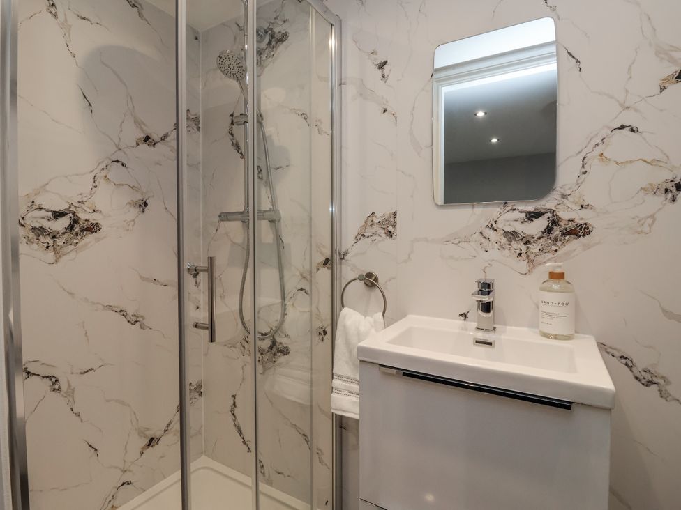 A bathroom with a shower and sink at Waters Edge in Skipton