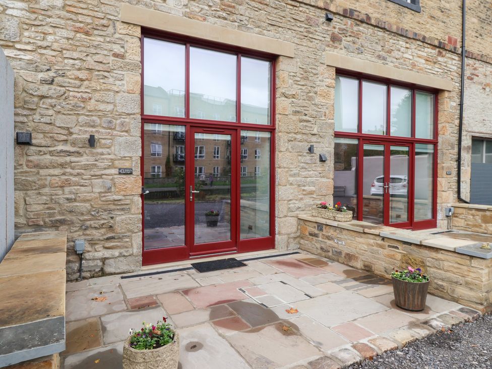 An outdoor area with large windows and doors at Waters Edge in Skipton