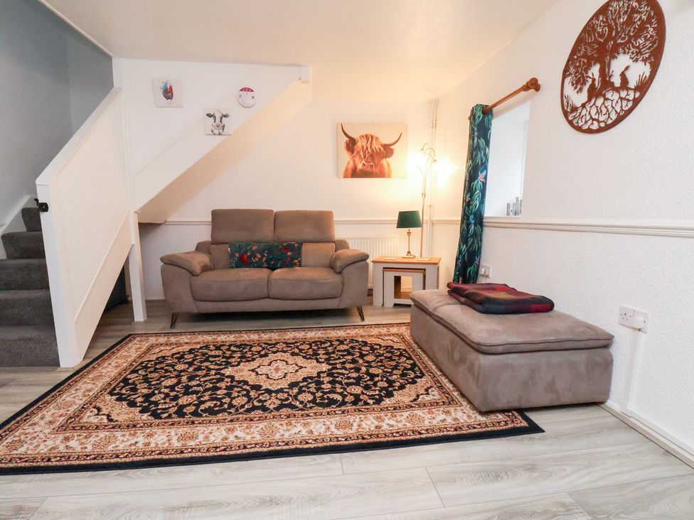 A living room with sofa and rug at Wayside Farm Dairy Cottage Cloughton near Burniston
