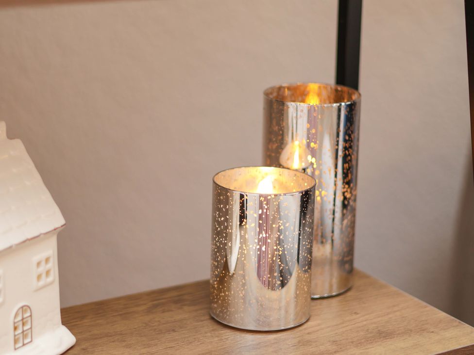 Candle holders on a wooden table at Wayside Farm Dairy Cottage Cloughton near Burniston