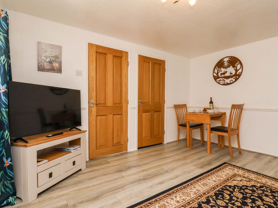 A dining room with a table and chairs at Wayside Farm Dairy Cottage Cloughton near Burniston